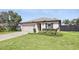 Well-maintained single-story home featuring a lush green lawn and an attached garage at 223 Courtland Blvd, Deltona, FL 32738