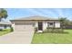 Charming single-story home with well-manicured lawn and attached garage at 223 Courtland Blvd, Deltona, FL 32738