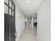 Bright hallway with tiled floors, coat hooks, and views into the kitchen and bedroom at 223 Courtland Blvd, Deltona, FL 32738
