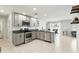Stylish kitchen featuring stainless steel appliances and dark granite countertops adjacent to a dining area at 223 Courtland Blvd, Deltona, FL 32738