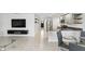 Open concept floor plan showing living room, dining area, and kitchen with stainless appliances at 223 Courtland Blvd, Deltona, FL 32738