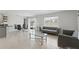 Open-concept living area with modern furniture and views of the backyard at 223 Courtland Blvd, Deltona, FL 32738