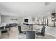 Open-concept living space with modern furnishings and eat-in kitchen featuring stainless steel appliances at 223 Courtland Blvd, Deltona, FL 32738