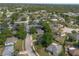 Aerial view showcasing the property within a residential neighborhood surrounded by mature trees at 227 Heronwood Cir, Deltona, FL 32725