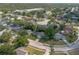 Overhead view of a home surrounded by mature trees, a lawn, and houses in the neighborhood at 227 Heronwood Cir, Deltona, FL 32725