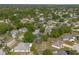 An aerial view of a home located amongst a heavily wooded residential neighborhood at 227 Heronwood Cir, Deltona, FL 32725
