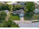 Aerial view of a home with a driveway, green lawn, mature trees, and surrounding neighborhood at 227 Heronwood Cir, Deltona, FL 32725