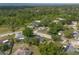 Aerial view of a home in a tree-lined residential area with a glimpse of the water at 227 Heronwood Cir, Deltona, FL 32725