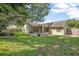 Spacious backyard with a well-maintained lawn and a screened-in patio at 227 Heronwood Cir, Deltona, FL 32725