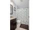 Cozy bathroom featuring a vanity with granite countertop and a shower with floral curtain at 227 Heronwood Cir, Deltona, FL 32725
