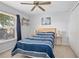 Comfortable bedroom with a window, ceiling fan and carpeted floors at 227 Heronwood Cir, Deltona, FL 32725