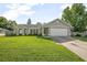 Charming one story home featuring a manicured lawn, neutral paint, and an attached two-car garage at 227 Heronwood Cir, Deltona, FL 32725