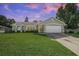 Charming one story home featuring a manicured lawn, neutral paint, and an attached two-car garage at 227 Heronwood Cir, Deltona, FL 32725