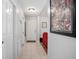 Well-lit entryway with tile flooring, white trim, and a red sofa in the adjacent living space at 227 Heronwood Cir, Deltona, FL 32725