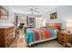 Bright main bedroom with ensuite bath, hardwood floors and a ceiling fan at 227 Heronwood Cir, Deltona, FL 32725