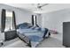 Bright bedroom featuring a ceiling fan, carpeted floors, and natural light from window with curtains at 2355 W Orange Rd, Deland, FL 32724