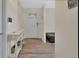 Hallway with side table, hard surface floors, front door, and access to other rooms at 2355 W Orange Rd, Deland, FL 32724