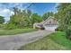 An exterior view of a single-story home with a well-kept lawn and an attached two-car garage at 2355 W Orange Rd, Deland, FL 32724