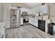 Bright kitchen featuring stainless steel appliances, white cabinets, and hard surface flooring at 2355 W Orange Rd, Deland, FL 32724