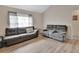 Living room with modern sofas, hard surface flooring, and bright natural lighting at 2355 W Orange Rd, Deland, FL 32724