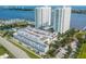 High-rise towers featuring a large parking garage, a pool, waterfront views, and lush greenery at 241 Riverside Dr # 2110, Daytona Beach, FL 32117