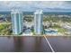 Expansive aerial view of high-rise towers, a pool, and scenic waterfront, offering a resort-style living at 241 Riverside Dr # 2110, Daytona Beach, FL 32117