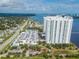 Aerial view of high-rise towers next to a waterway with parking, landscaping, and nearby amenities at 241 Riverside Dr # 2110, Daytona Beach, FL 32117