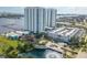 Aerial view of condo buildings with beautiful landscaping, a water feature, and convenient parking at 241 Riverside Dr # 2110, Daytona Beach, FL 32117