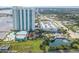 Stunning aerial view of the high-rise community featuring lush landscaping, a pool, and waterfront access at 241 Riverside Dr # 2110, Daytona Beach, FL 32117