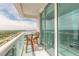 Inviting balcony with glass railings and a bistro table set with lovely views at 241 Riverside Dr # 2110, Daytona Beach, FL 32117