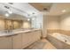 Elegant bathroom with double sinks, soaking tub, and a glass enclosed shower at 241 Riverside Dr # 2110, Daytona Beach, FL 32117