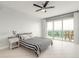 Bright bedroom with floor to ceiling windows and access to private balcony with bistro seating at 241 Riverside Dr # 2110, Daytona Beach, FL 32117