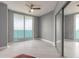 Bright bedroom with tile floors and sliding glass doors to balcony, and closet with sliding mirrored doors at 241 Riverside Dr # 2110, Daytona Beach, FL 32117