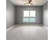 The bedroom offers tile floors, a ceiling fan and light fixture, and a window with a lovely view at 241 Riverside Dr # 2110, Daytona Beach, FL 32117
