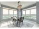Bright dining room featuring a modern chandelier, large windows with great views, and stylish furniture at 241 Riverside Dr # 2110, Daytona Beach, FL 32117
