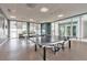 Spacious game room featuring ping pong tables, large windows, and comfortable seating areas at 241 Riverside Dr # 2110, Daytona Beach, FL 32117