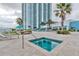 Modern jacuzzi and pool area featuring a spa and resort-style amenities next to a modern high rise at 241 Riverside Dr # 2110, Daytona Beach, FL 32117