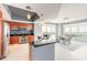 Modern kitchen with stainless steel appliances, sleek countertops, mosaic backsplash, and an adjacent dining area at 241 Riverside Dr # 2110, Daytona Beach, FL 32117