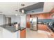 Modern kitchen featuring stainless steel appliances, sleek cabinetry, granite countertops, and tile flooring throughout at 241 Riverside Dr # 2110, Daytona Beach, FL 32117