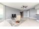 Spacious living room with tile floors and access to the kitchen area and scenic views through floor-to-ceiling windows at 241 Riverside Dr # 2110, Daytona Beach, FL 32117