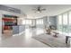Bright living room featuring tile floors, modern furniture, and floor-to-ceiling windows with stunning views at 241 Riverside Dr # 2110, Daytona Beach, FL 32117