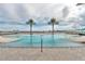 Community pool with palm trees featuring inviting spaces for recreation and leisure at 241 Riverside Dr # 2110, Daytona Beach, FL 32117