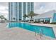 Resort-style pool area with palm trees offering a luxurious experience in front of the high-rise condo building at 241 Riverside Dr # 2110, Daytona Beach, FL 32117