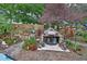 Outdoor kitchen featuring stainless steel grill, ample counter space, and lush landscaping, ideal for entertaining at 2427 Beck Cir, Deltona, FL 32738