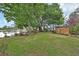 Large backyard featuring lush green grass, mature trees, and a serene pond, perfect for outdoor activities and relaxation at 2427 Beck Cir, Deltona, FL 32738
