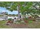 Backyard oasis with pond views, mature trees, lush landscaping, and a cozy seating area for relaxation by the water at 2427 Beck Cir, Deltona, FL 32738