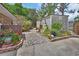 Backyard features a charming shed surrounded by vibrant gardens and stone pathways at 2427 Beck Cir, Deltona, FL 32738