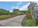 Long driveway leading to a charming home with a lush, landscaped front yard and manicured shrubbery at 2427 Beck Cir, Deltona, FL 32738