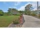 View of the driveway leading up to the home, showcasing the landscaped yard with plants and shrubbery at 2427 Beck Cir, Deltona, FL 32738