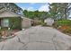 Exterior view of the house featuring a long cracked driveway with greenery surrounding the house at 2427 Beck Cir, Deltona, FL 32738